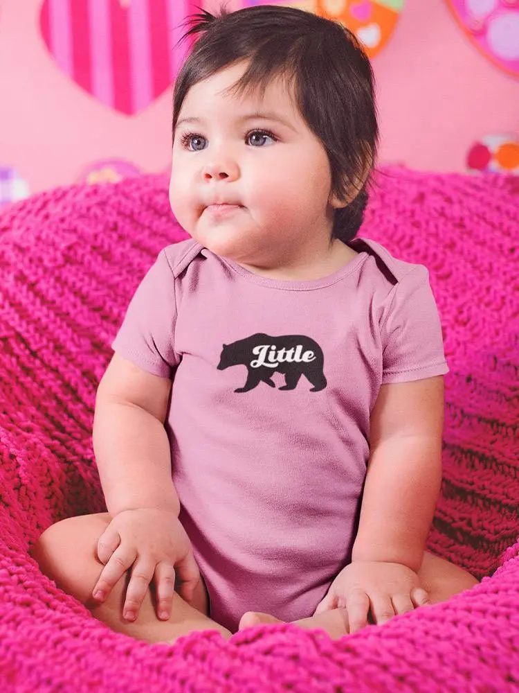 a baby sitting on a pink blanket