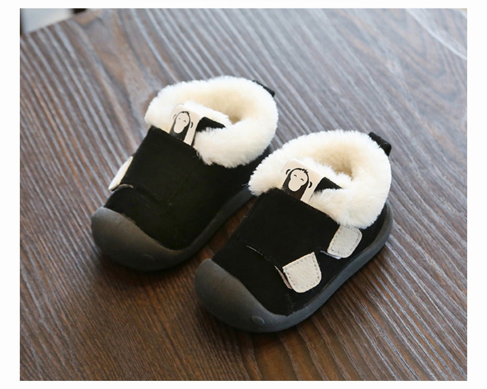 a pair of black and white baby shoes