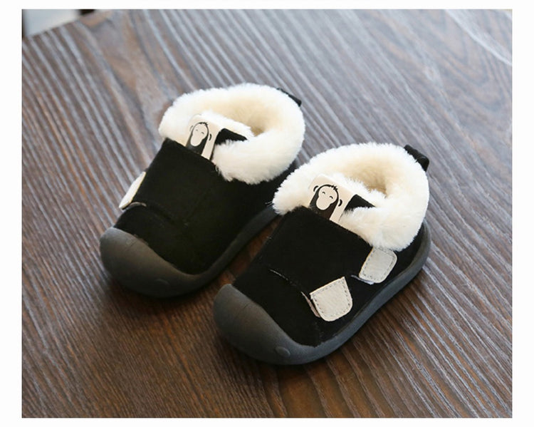 a pair of black and white baby shoes