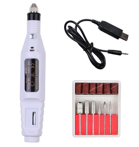 a white electric nail drill and a box of bits