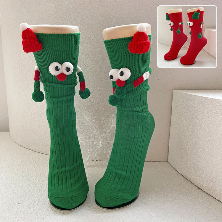 a pair of green socks with eyes and a red hat