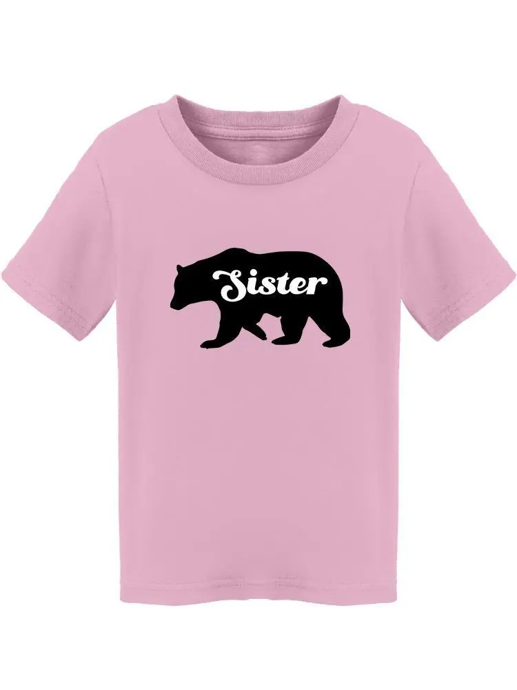 a pink shirt with a bear and white text