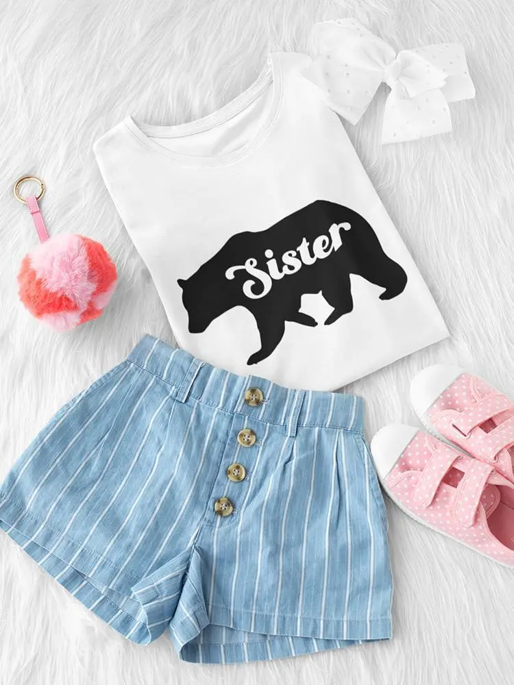 a pair of pink shoes and a white shirt with a bear on it