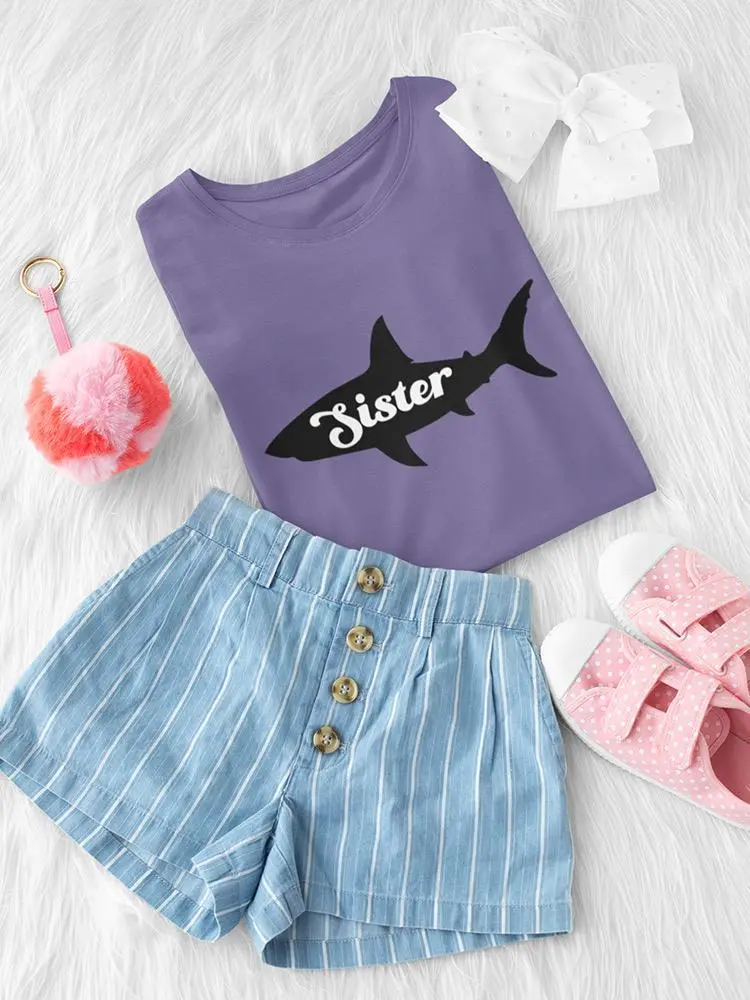 a purple shirt and shorts on a white fur surface