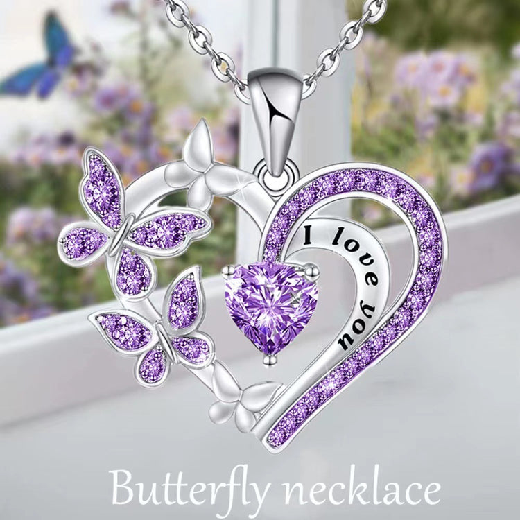 a silver heart with purple stones and butterflies on a chain