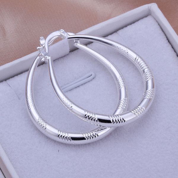 a pair of silver hoop earrings in a box