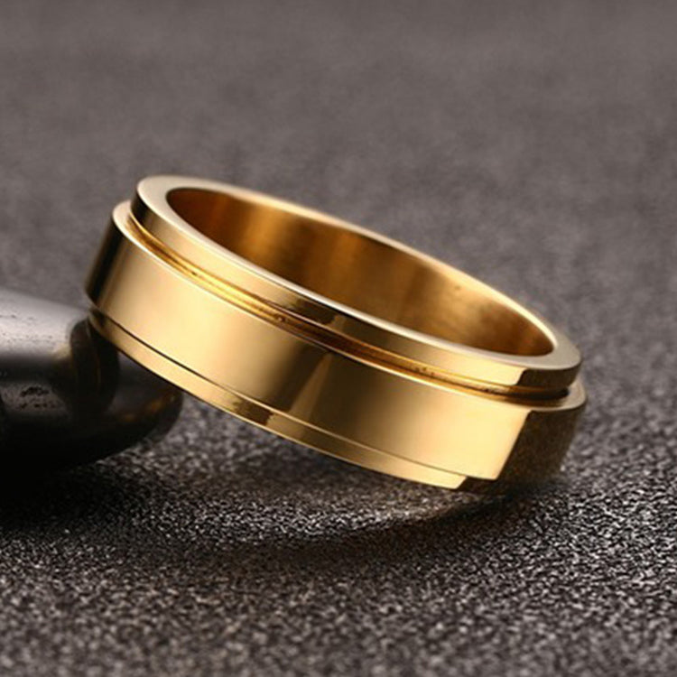 a gold ring on a black surface
