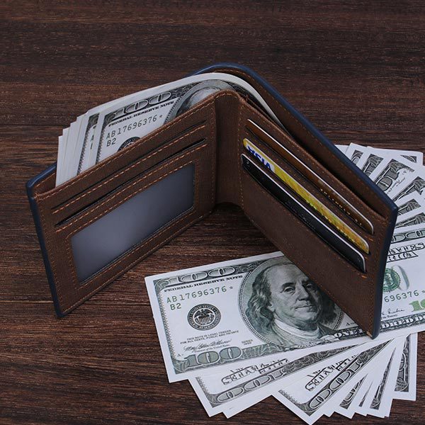 a wallet with money on top of it