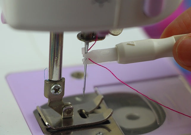 a sewing machine with a needle and thread