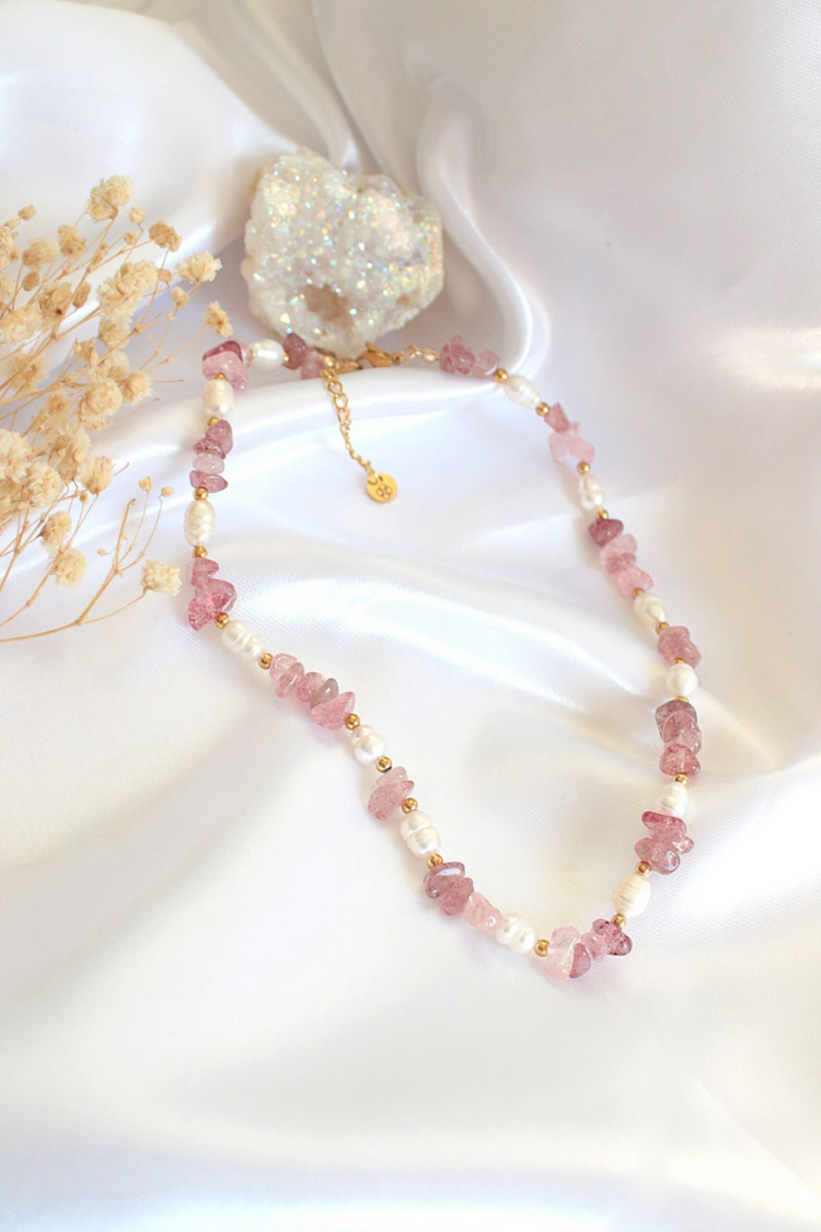 a necklace on a white fabric