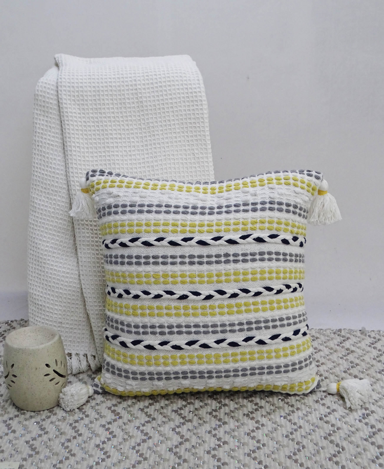 a pillow and blanket on a rug