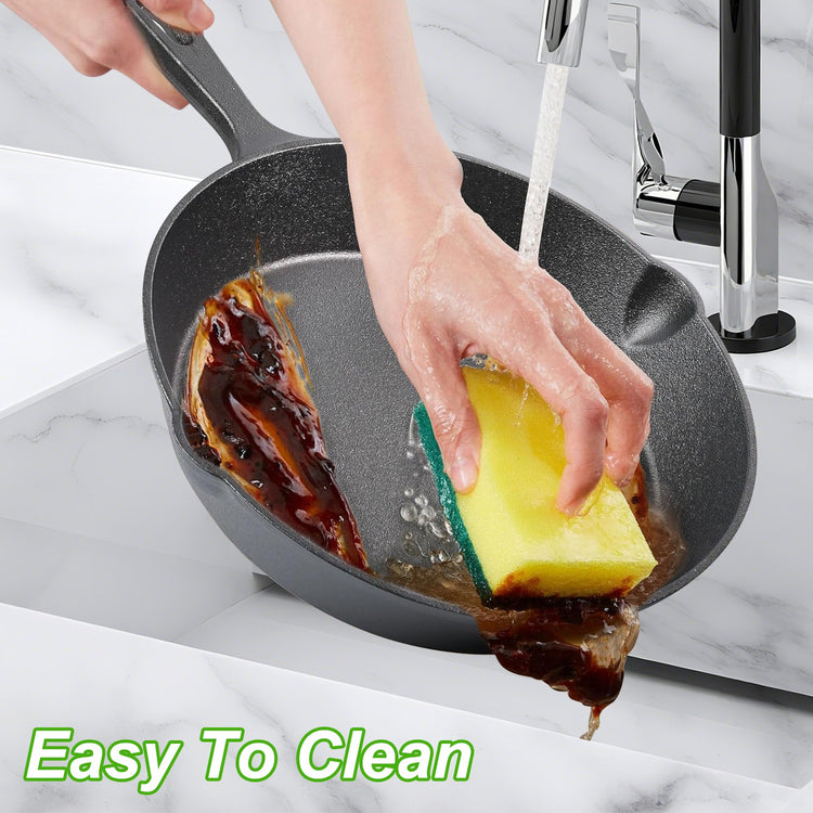 a person washing a pan with a sponge