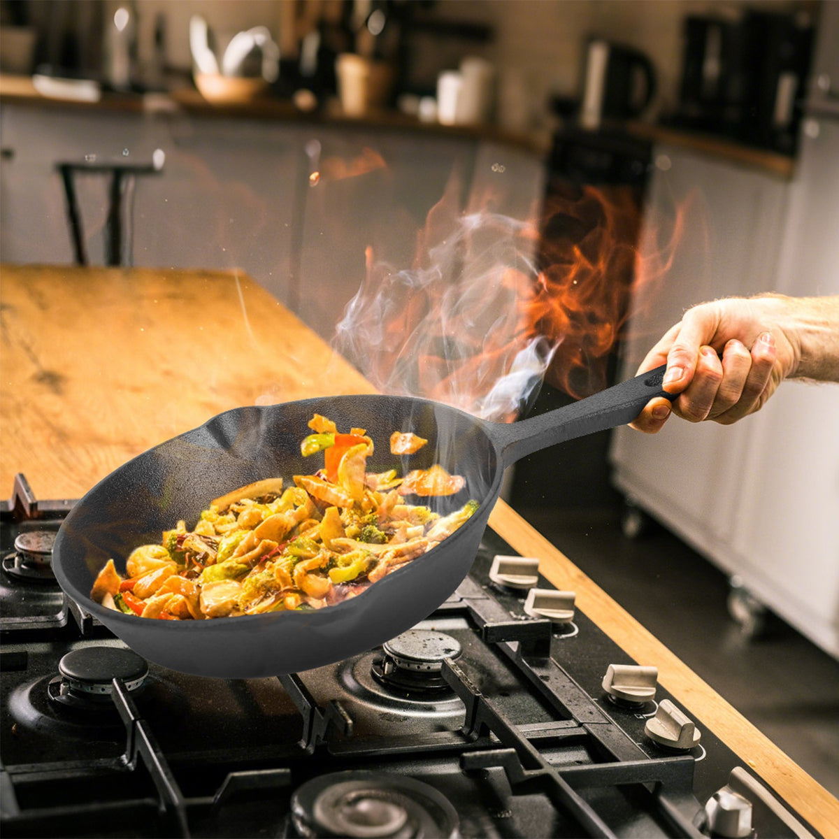 a hand holding a pan over a stove