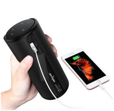 a hand holding a speaker and a phone