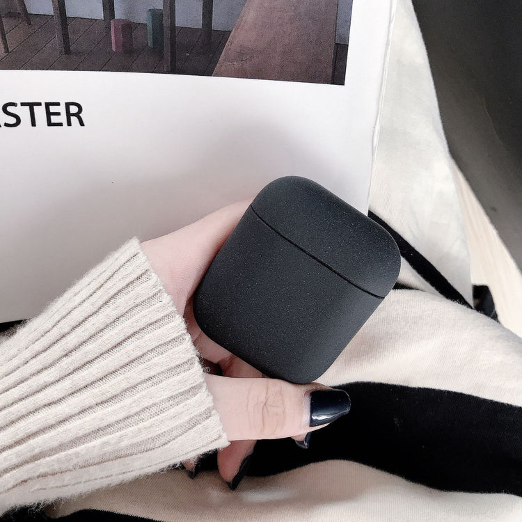 a hand holding a black container