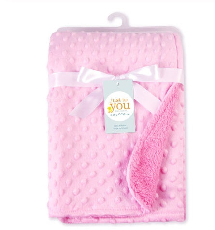 a pink blanket with a white bow