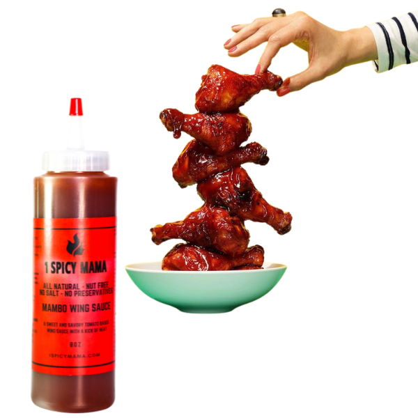 a hand holding a stack of chicken wings