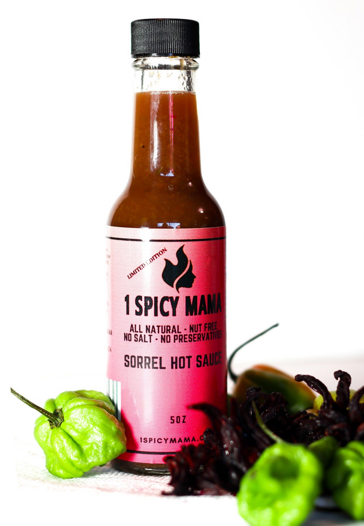 a bottle of hot sauce next to green peppers