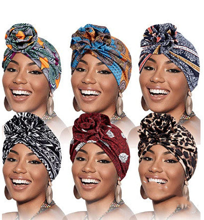 a woman smiling with different colored turbans