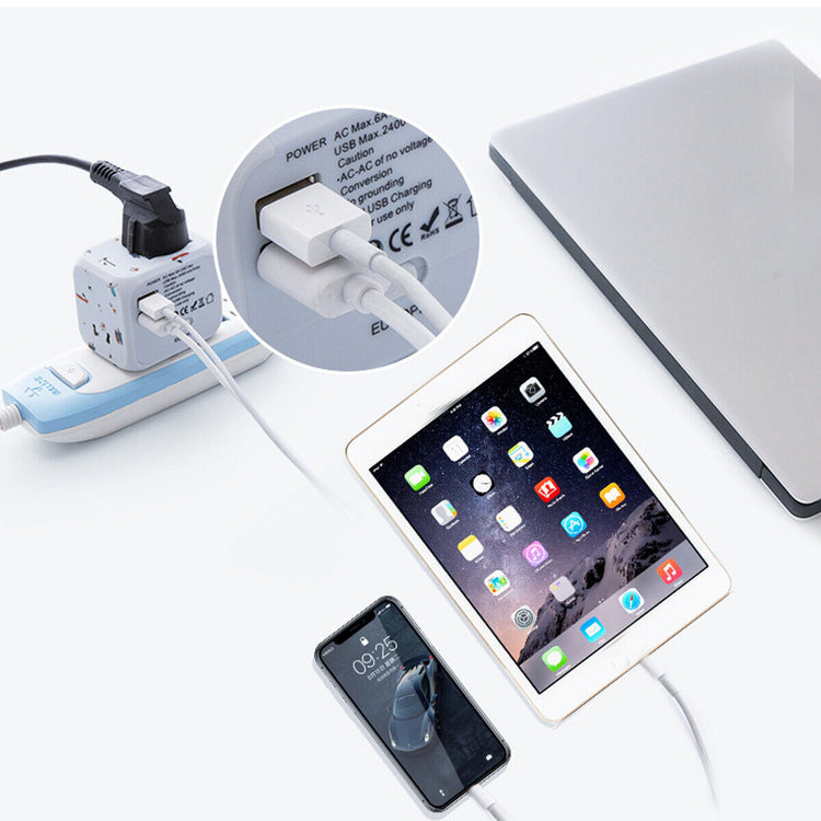 a laptop and a charger with a power strip