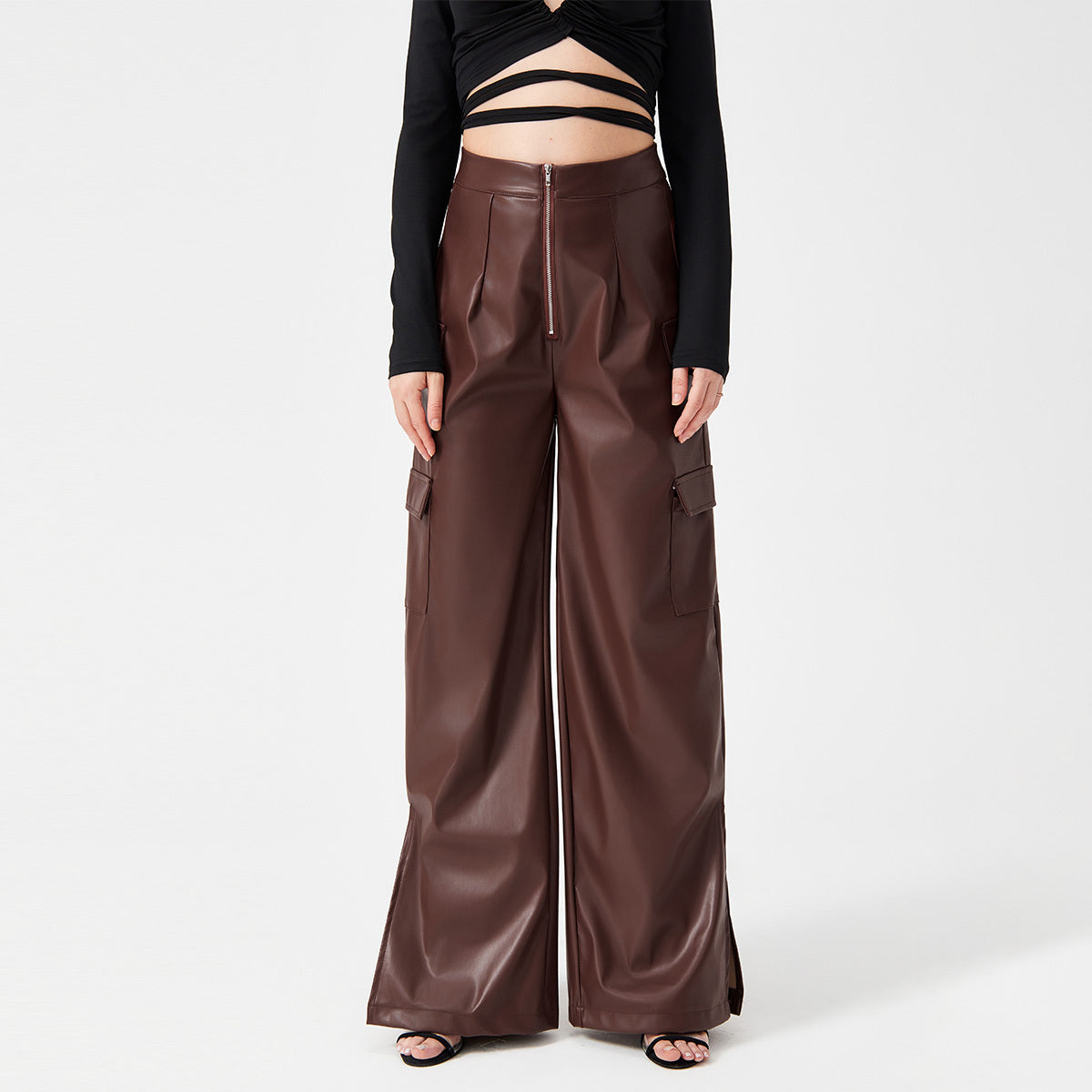 a woman wearing a black top and brown pants
