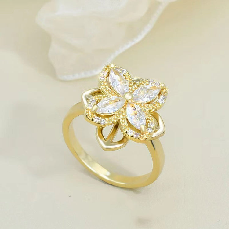 a gold ring with a flower design