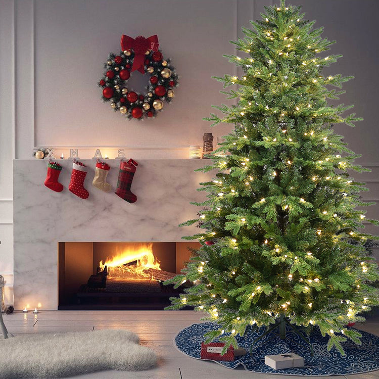 a christmas tree with lights and a fireplace