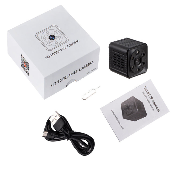 a small camera with a paper clip and a paper clip