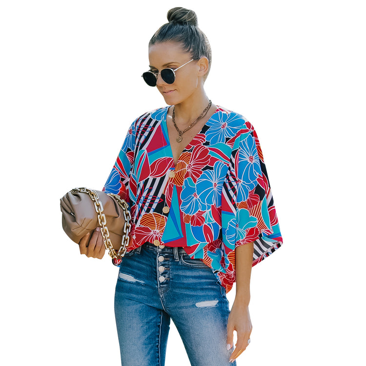 a woman wearing sunglasses and a colorful shirt