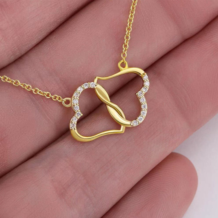 a hand holding a gold necklace