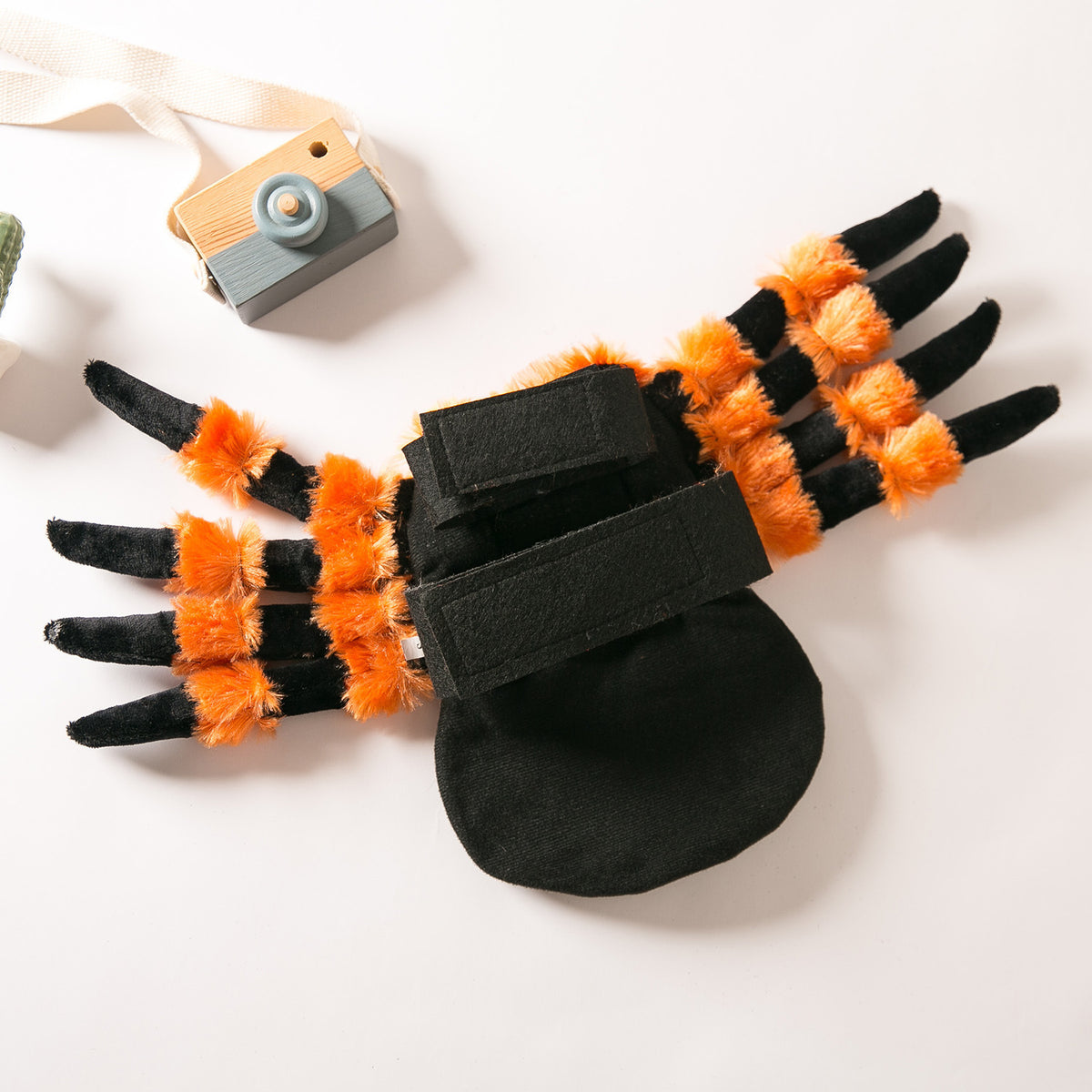 a toy spider with orange and black fur