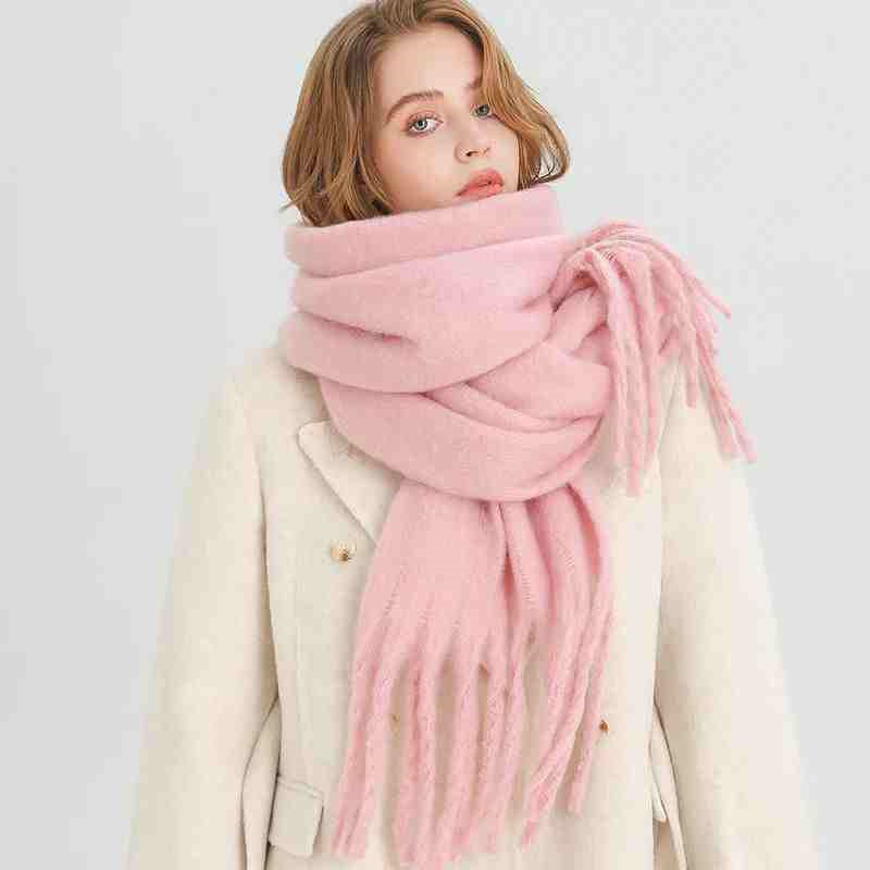 a woman wearing a pink scarf