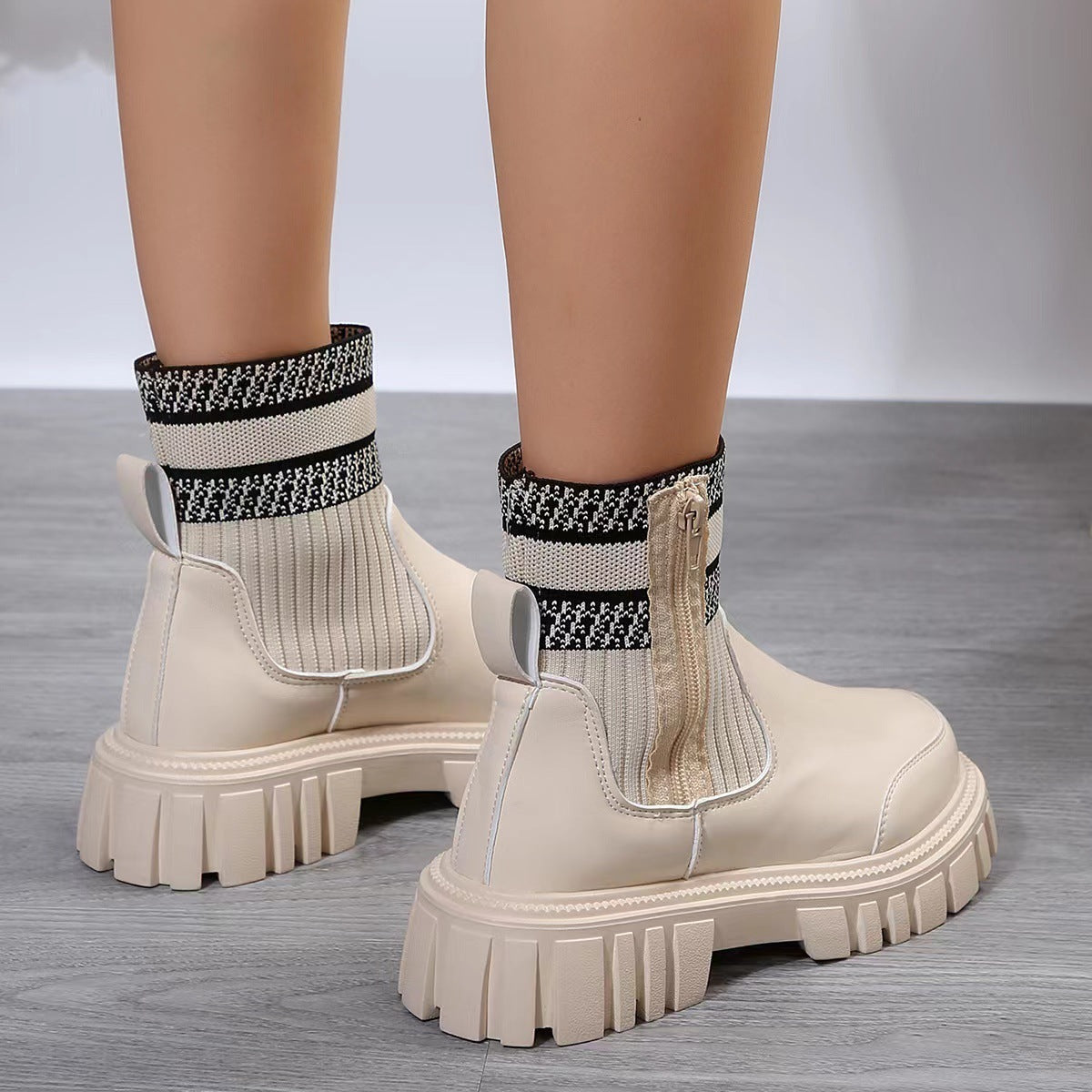 a pair of legs wearing white boots