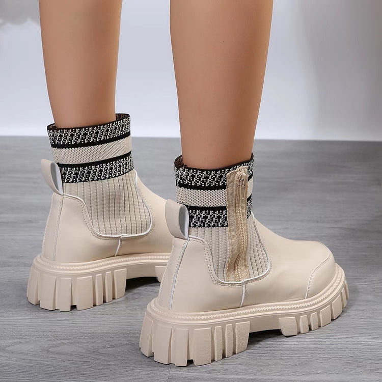 a pair of legs wearing white boots