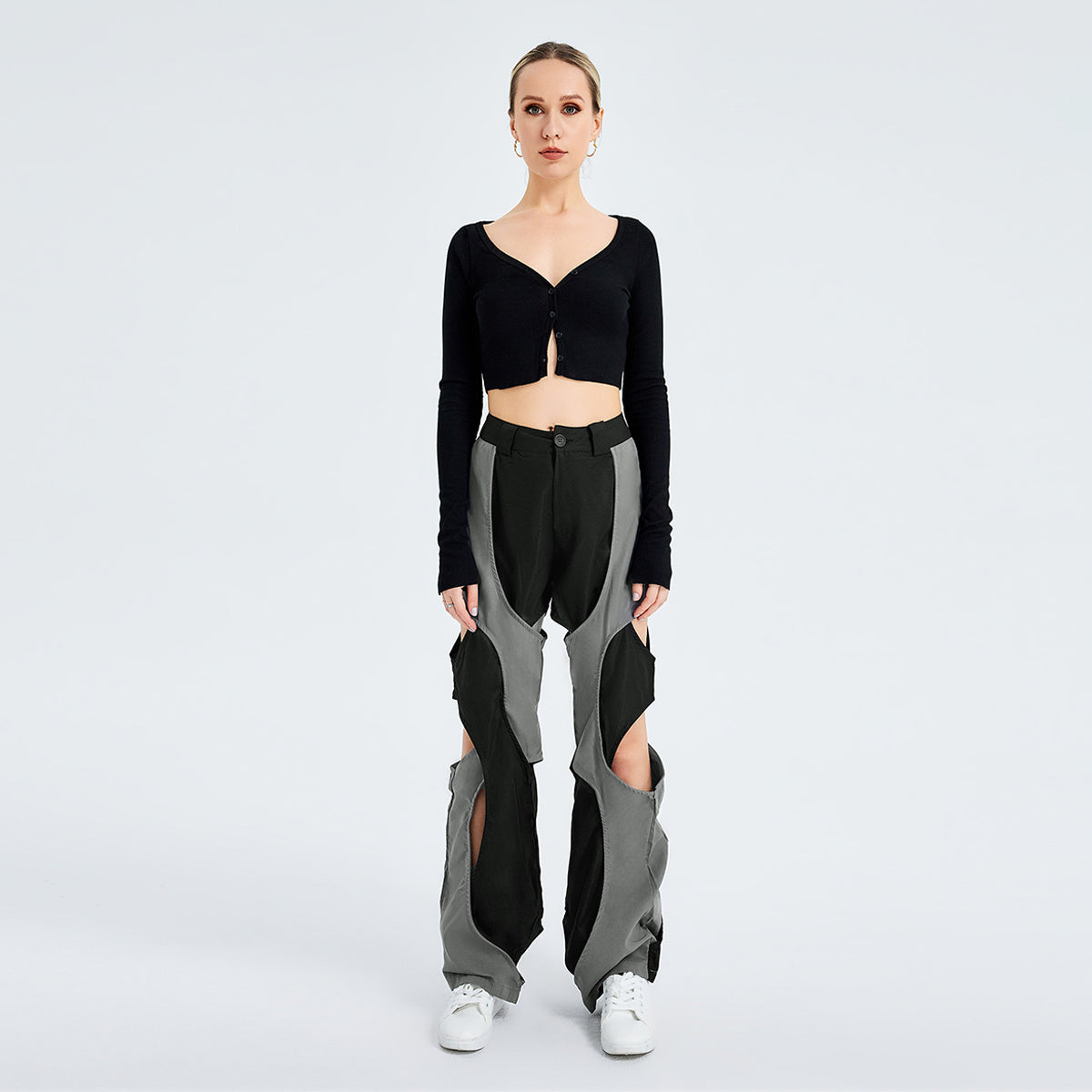 a woman in a black top and grey pants