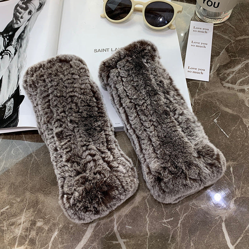 a pair of fur gloves on a table
