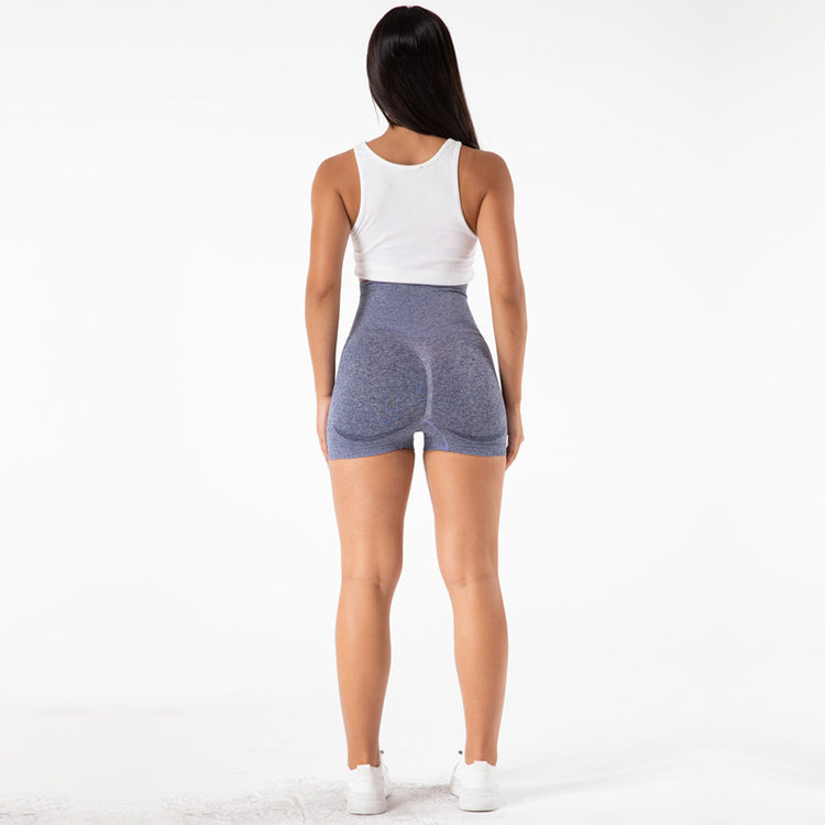 a woman in shorts and a tank top