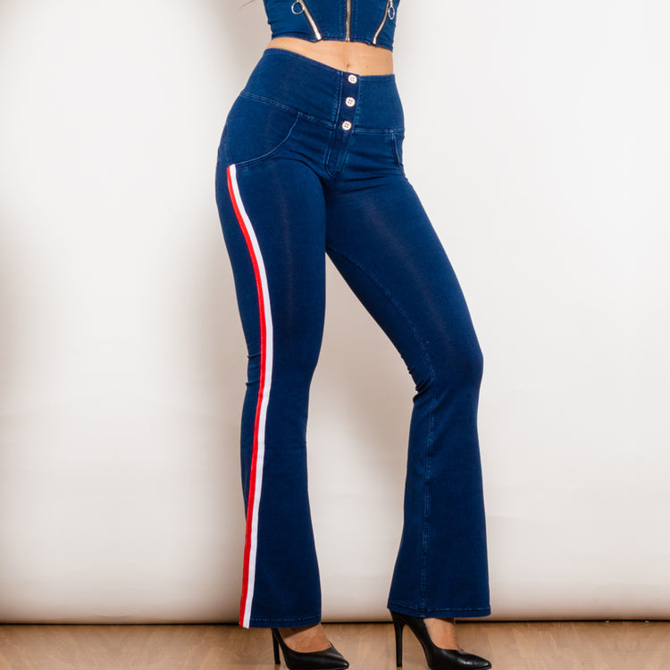 a woman wearing blue jeans and a crop top
