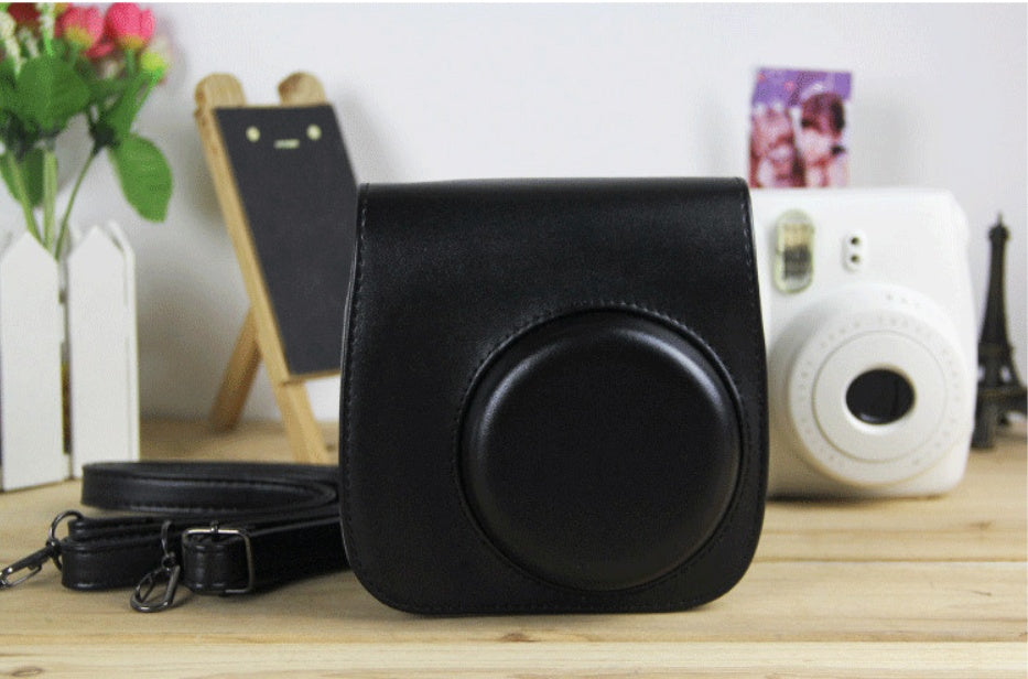 a camera case and belt on a table
