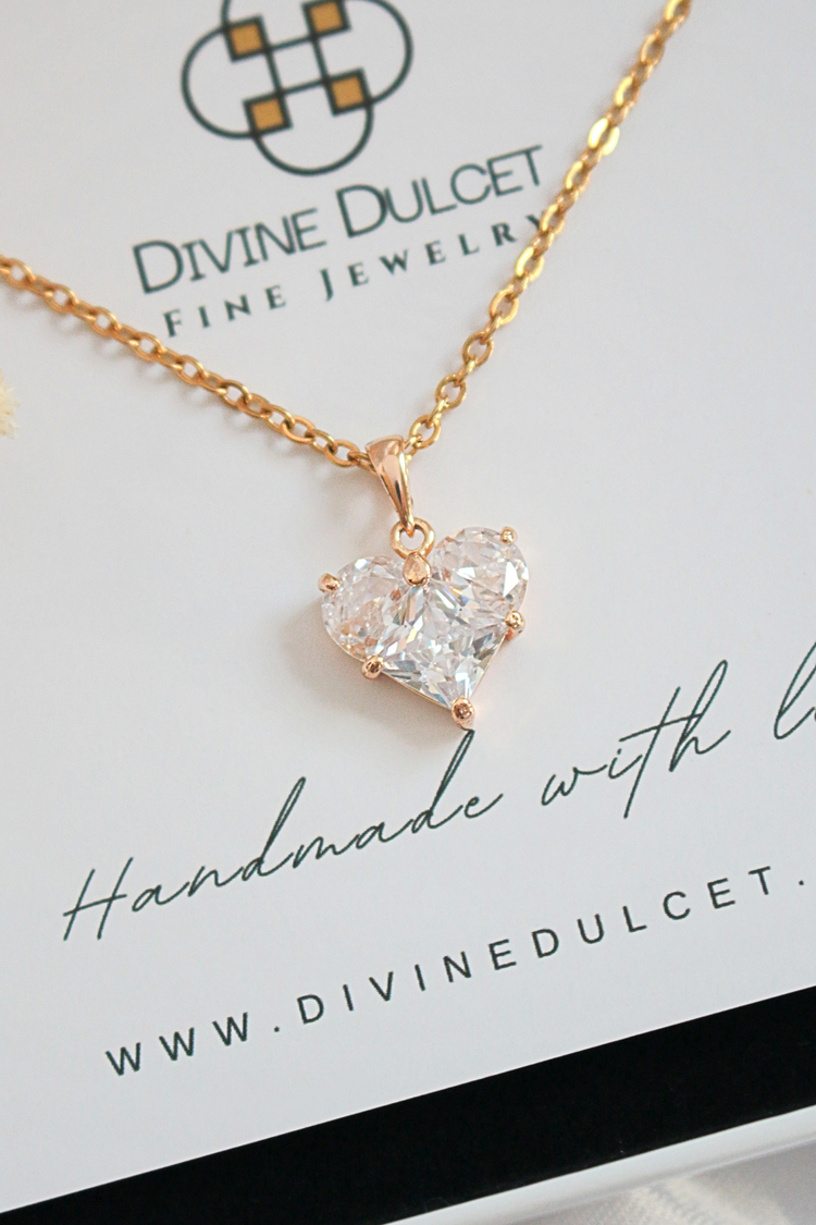 a heart shaped necklace on a gold chain