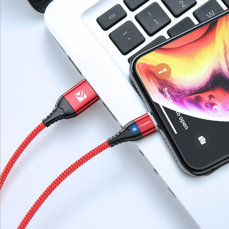 a cell phone charging on a laptop