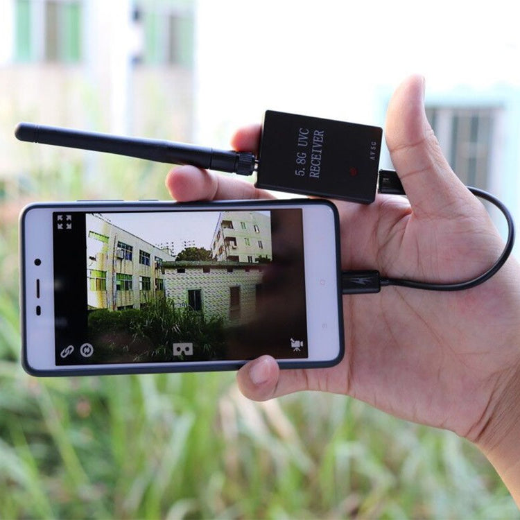 a hand holding a phone with a antenna attached to it