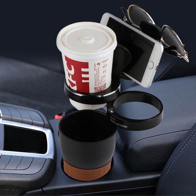 a cup holder with a phone and a phone on it