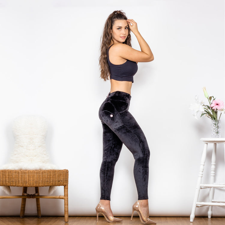 a woman in black pants and a tank top