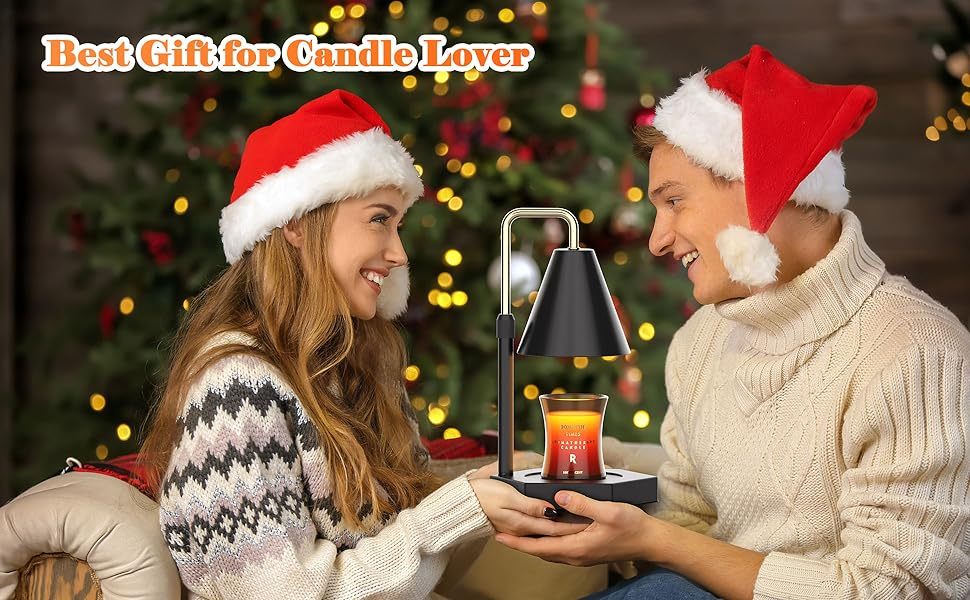 a man and woman wearing santa hats holding a candle