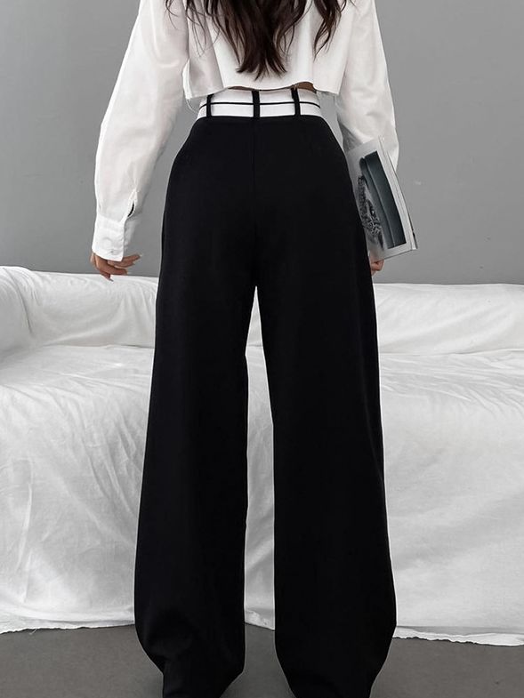 a woman wearing black pants and white shirt