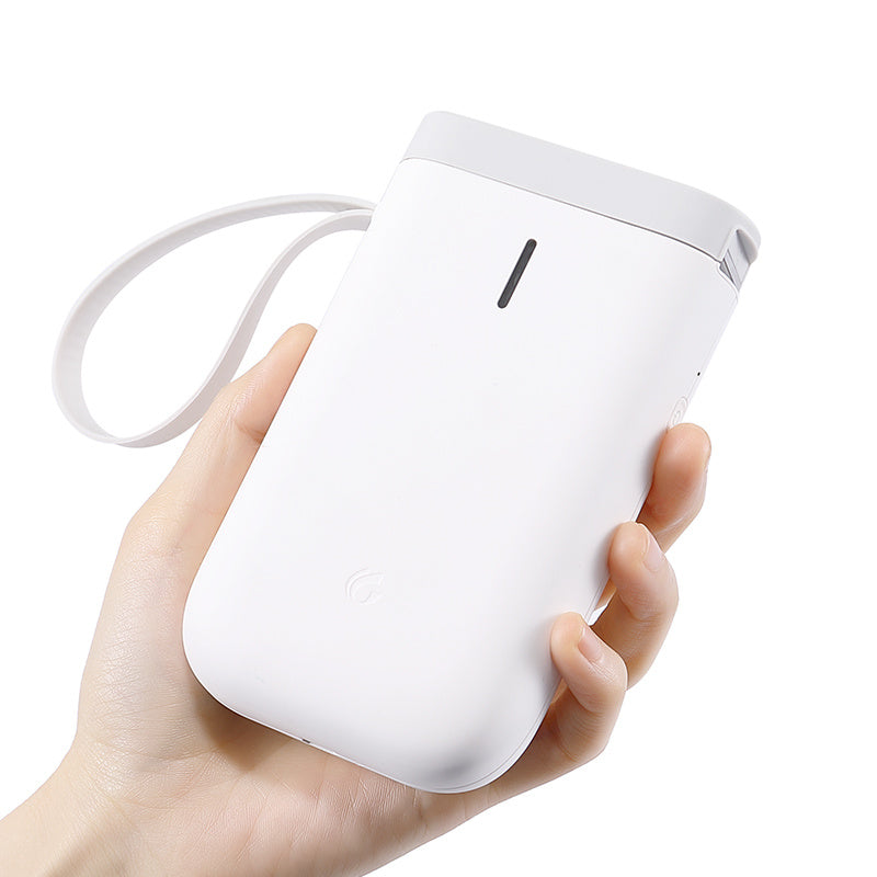 a hand holding a white device