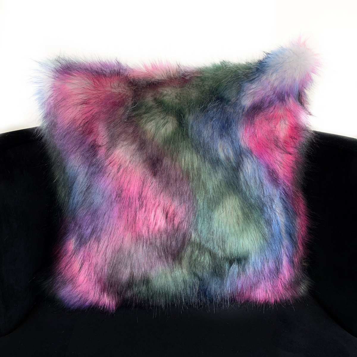 a colorful pillow on a chair
