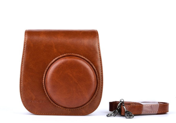 a brown leather case with a camera lens attached
