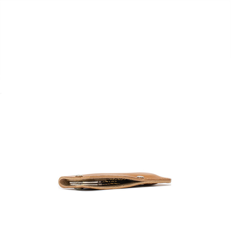 a brown leather wallet with silver buttons